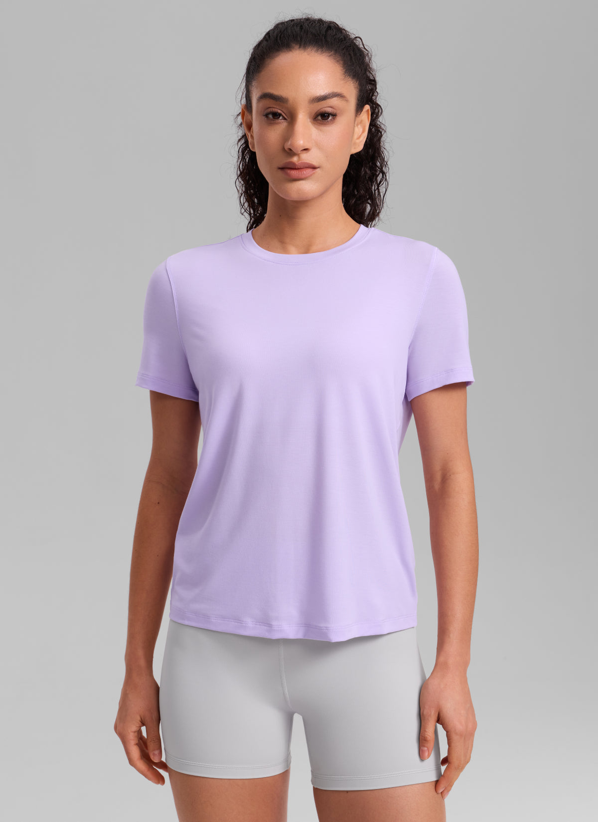 CRZ YOGA Women's Quick Dry Workout Crewneck Hip Length Short Sleeve Lavender Frost @model_info:Larissa